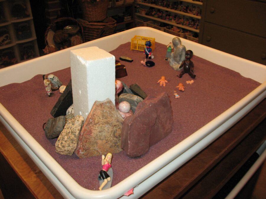 A sandbox with small toys Description automatically generated with medium confidence